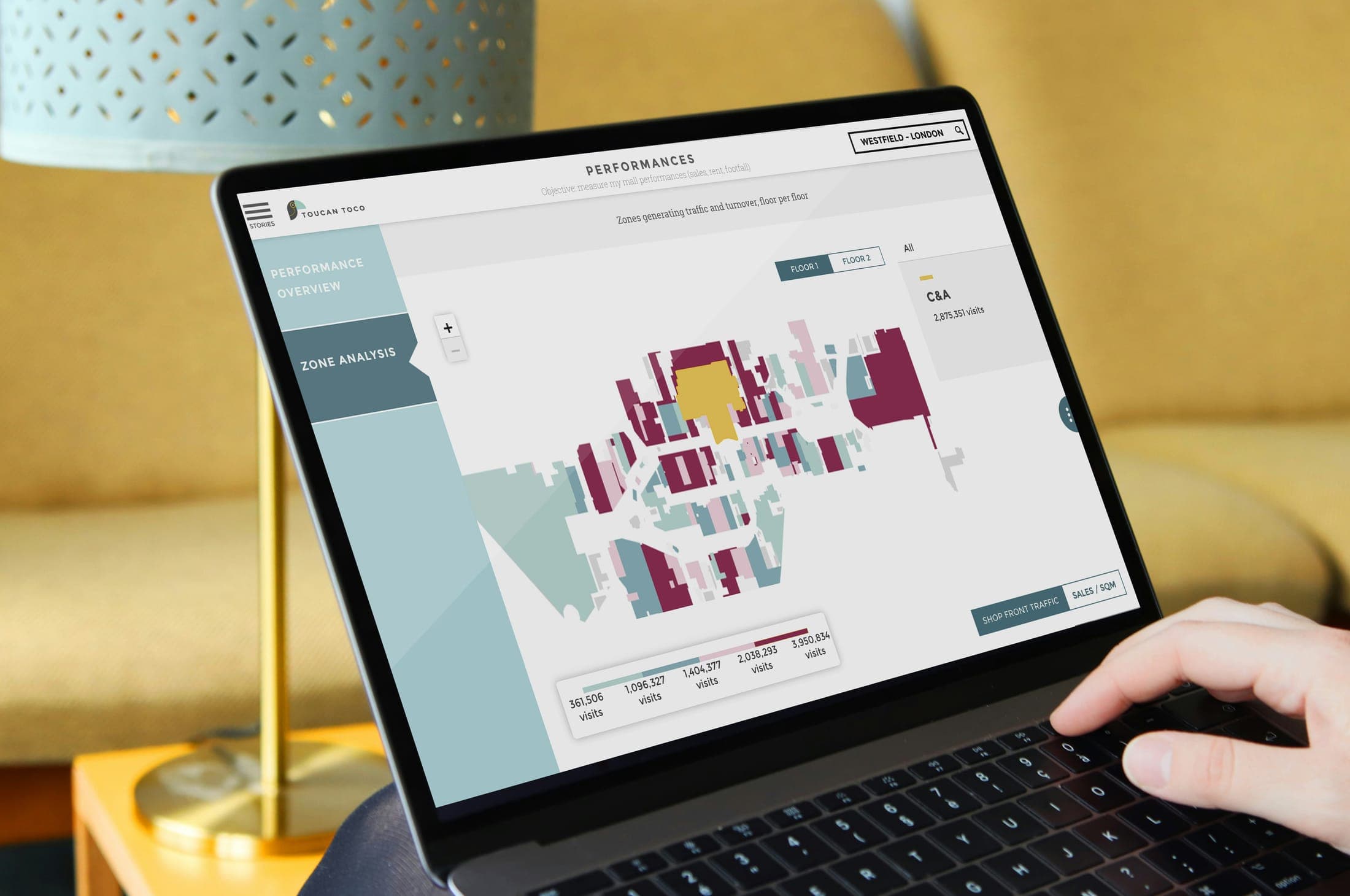 A laptop showing an analytics dashboard with a floor map
