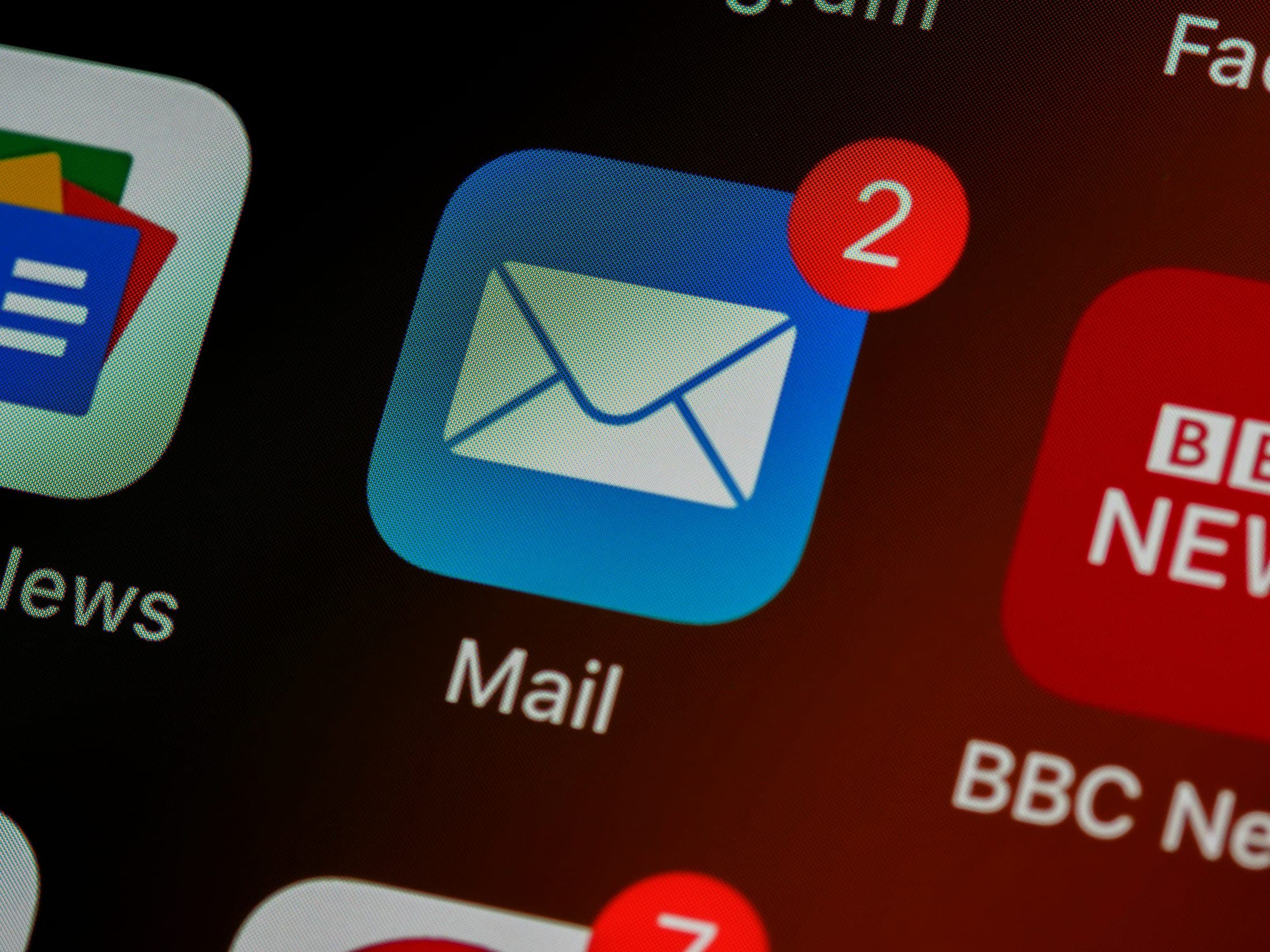 Close-up of a phone screen with a mail app showing two notifications